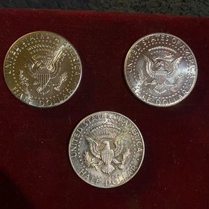 Three Kennedy half dollars that came out of a $10 roll